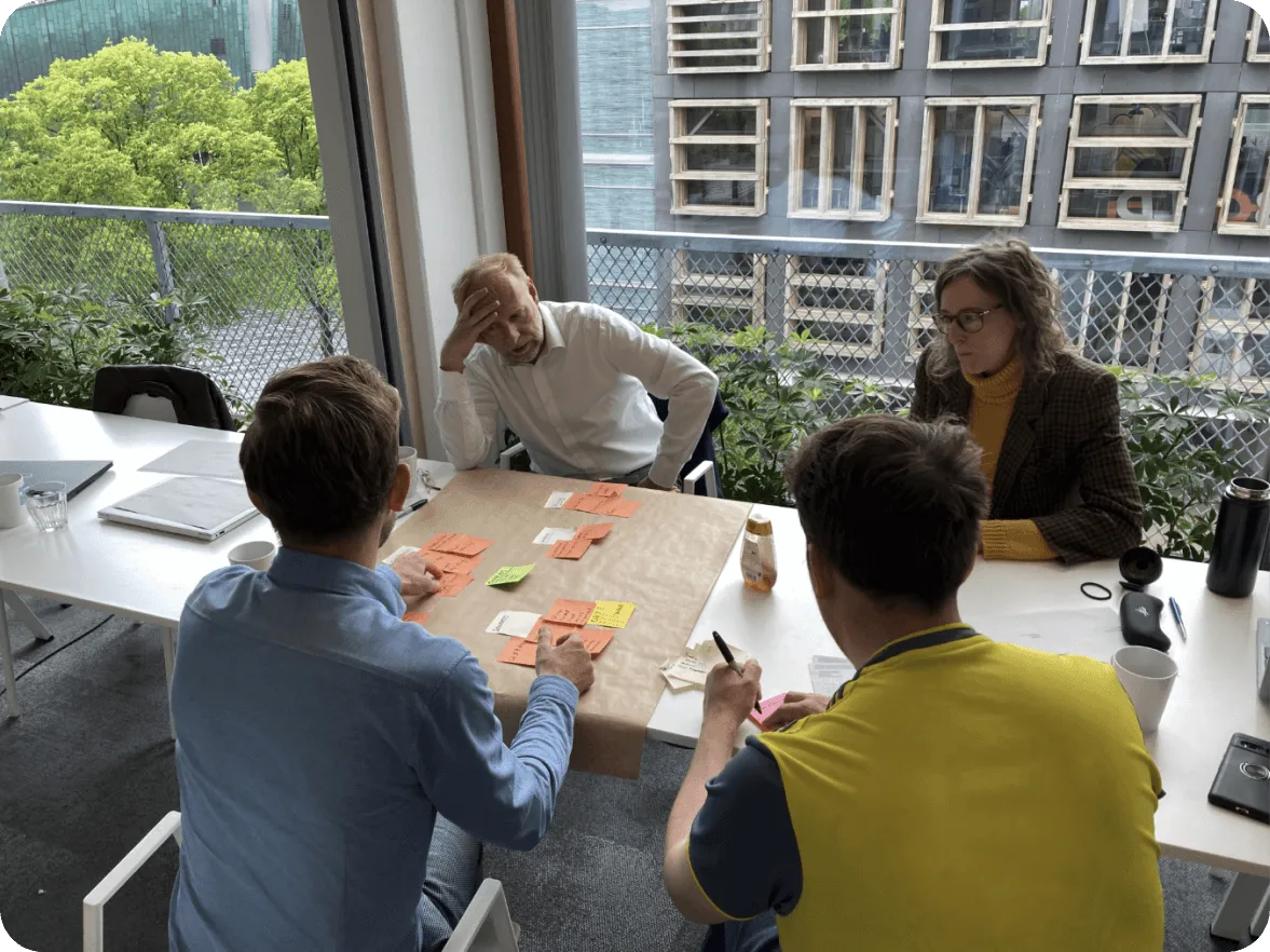 A group of people sitting around a table.
